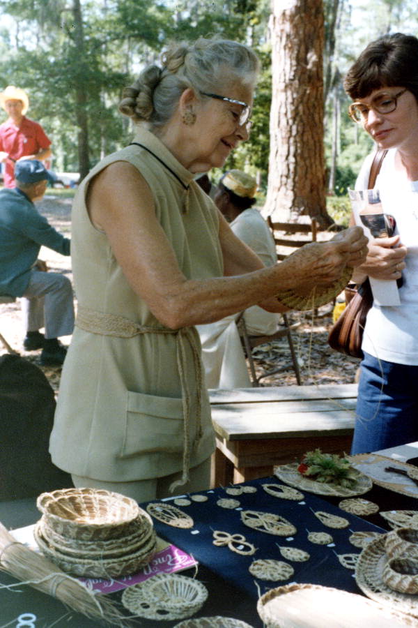 Iva Campbell, of Miami, showing her pine needle crafts- White Springs, Florida