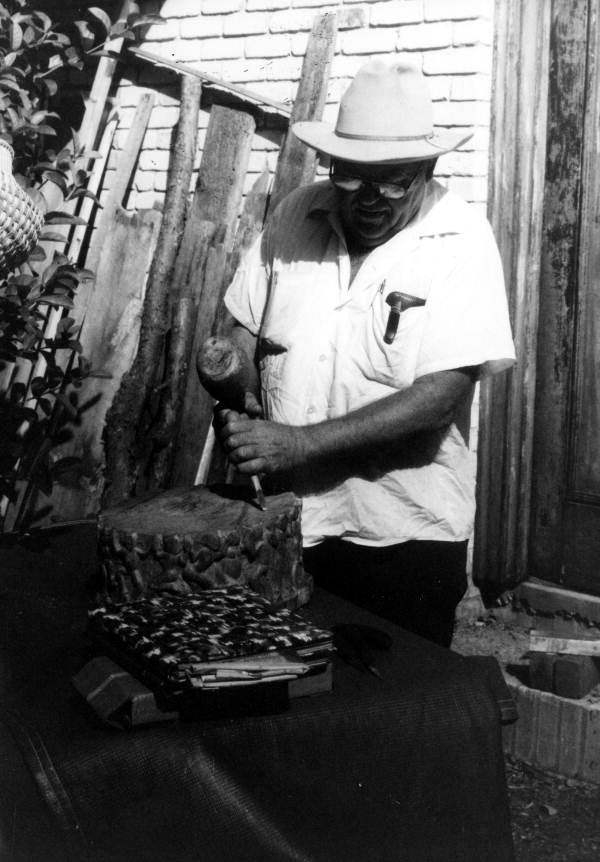 John Albert carving a piece of wood- Tampa, Florida.