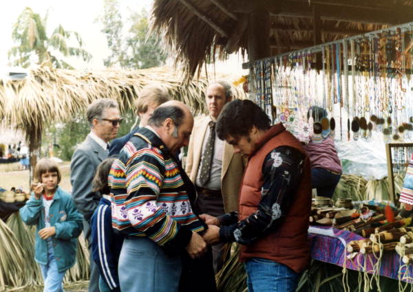 Secretary of State George Firestone being fitted with a Seminole jacket