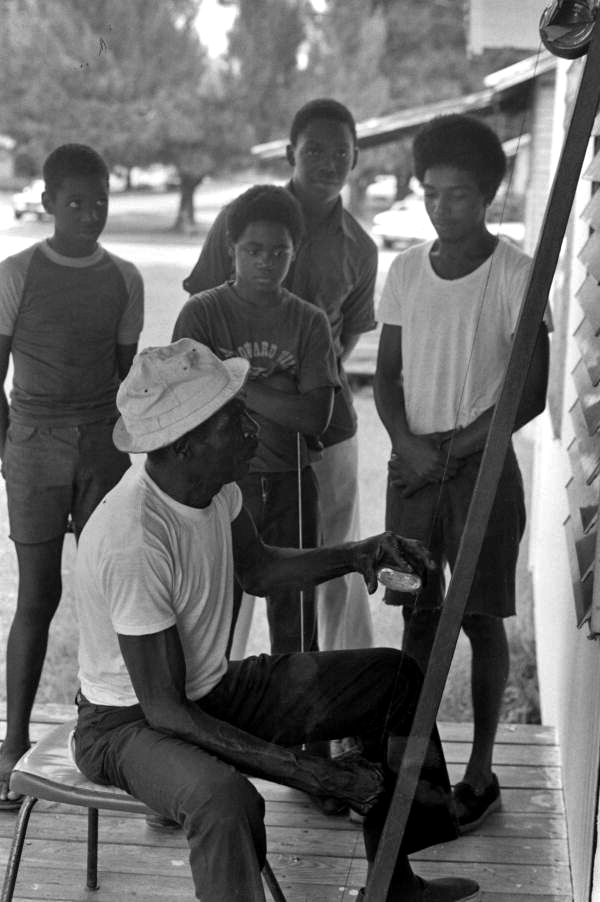 Moses Williams playing the diddley bow for a group of boys- Waverly, Florida