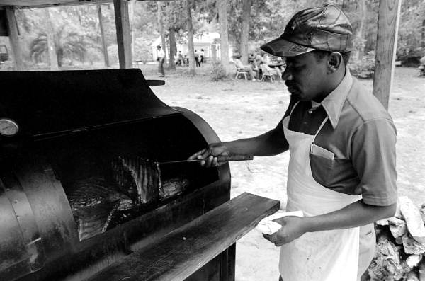 Man from the Community Revival Center cooking food at the 1983 Florida Folk Festival - White Springs, Florida