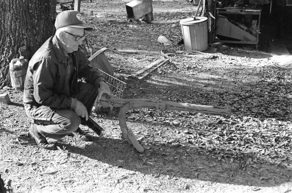 Lloyd Earl McMullian on his farm with old one-mule plow - Two Egg, Florida