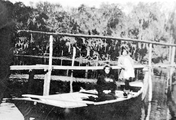 Mrs. Lena B. Cole and Rosalee Cole in boat built by A.A. Cole..