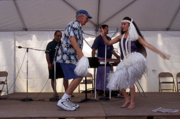 Kaleinani Ohumukini dances with an unidentified man while Henry Ohumukini and James Buchin plays at Florida Folklife Festival - White Springs, Florida.