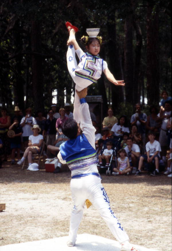 Dan Dan Zhao hold Xuefei Leng in the air at the Florida Folklife Festival - White Springs, Florida.