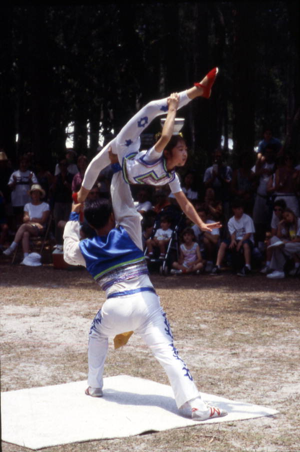 Xuefei Leng holds Dan Dan Zhao in the air at the Florida Folklife Festival - White Springs, Florida.