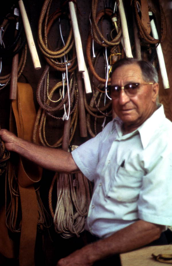 Whip maker, Claude Sheppard, standing by his collection of whips - Gainesville, Florida.