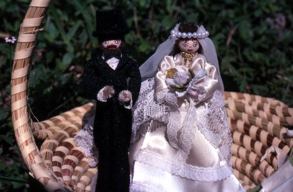 Bride and groom dolls in a homemade basket