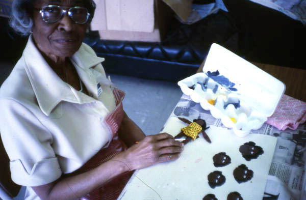 Mrs. Cheek picking from different facial expressions to put on her doll - Miami, Florida.