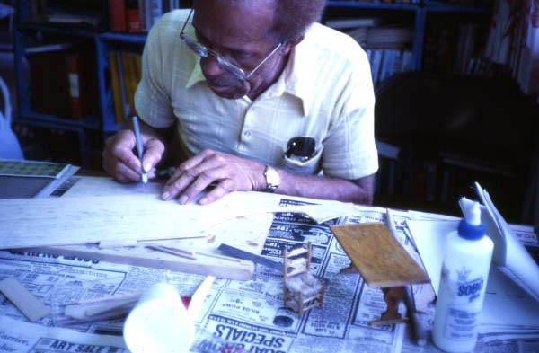Mr. Ellis cutting furniture pieces for a doll house - Miami, Florida.