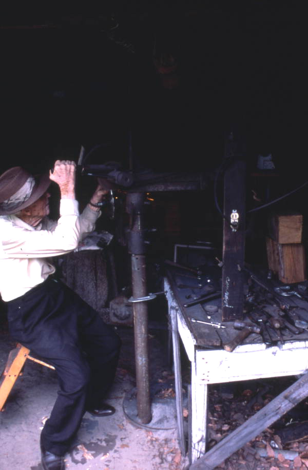 W.H. Hammack working on a metal object- Jasper, Florida