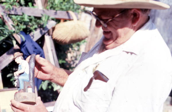 John Albert holding a wood sculpture he made- Tampa, Florida