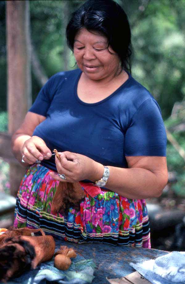 Mary Billie threading a Seminole doll body to prepare for the head - Big Cypress Reservation, Florida
