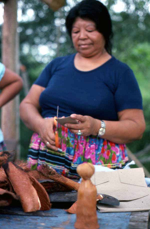 Mary Billie cutting cardboard for the Seminole doll she is making - Big Cypress Reservation, Florida