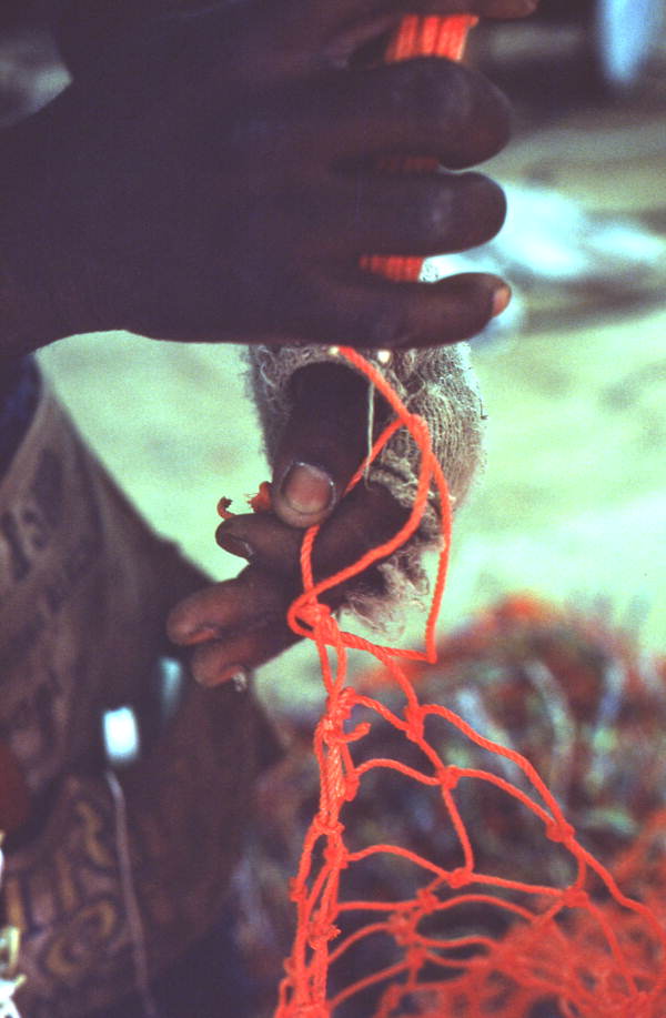 Worker repairing a fishing net - Fernandina Beach, Florida
