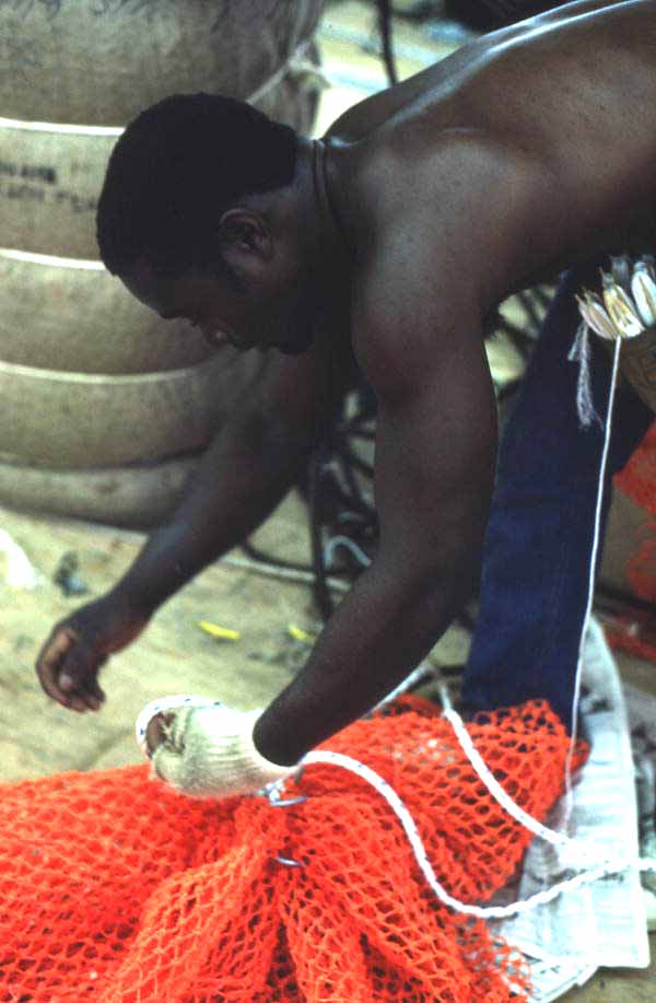 Worker repairing a fishing net - Fernandina Beach, Florida