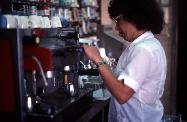Cuban American woman preparing cup of coffee at Cafe Cubano in Little Havana - Miami, Florida.