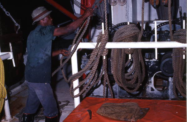 Shrimper at work pulling rope aboard the "Capt. Daddy" - Fernandina Beach, Florida