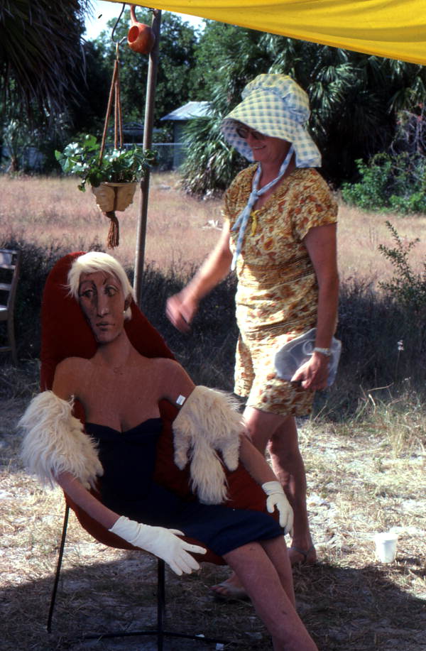 Artisan and a doll sitting in a chair
