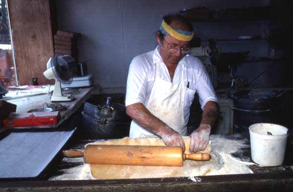 Marty Kaufmann rolling dough into knishes at Suzanne's Foods - Miami, Florida.