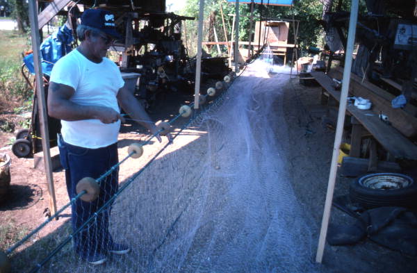Sonny Polous working on a monofilament mullet net - Apalachicola, Florida