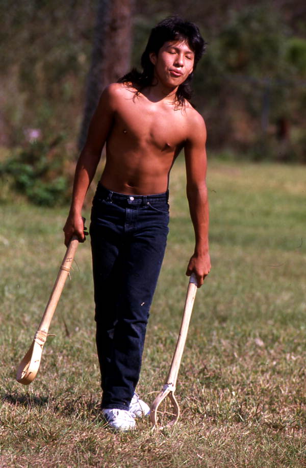 Boy playing stick ball - Big Cypress Reservation, Florida