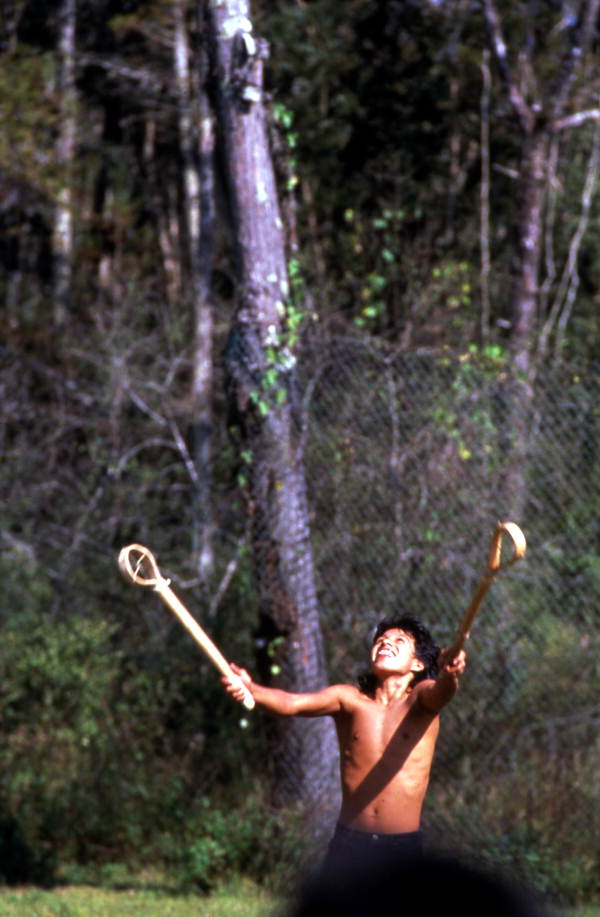 Boy playing stick ball - Big Cypress Indian Reservation, Florida