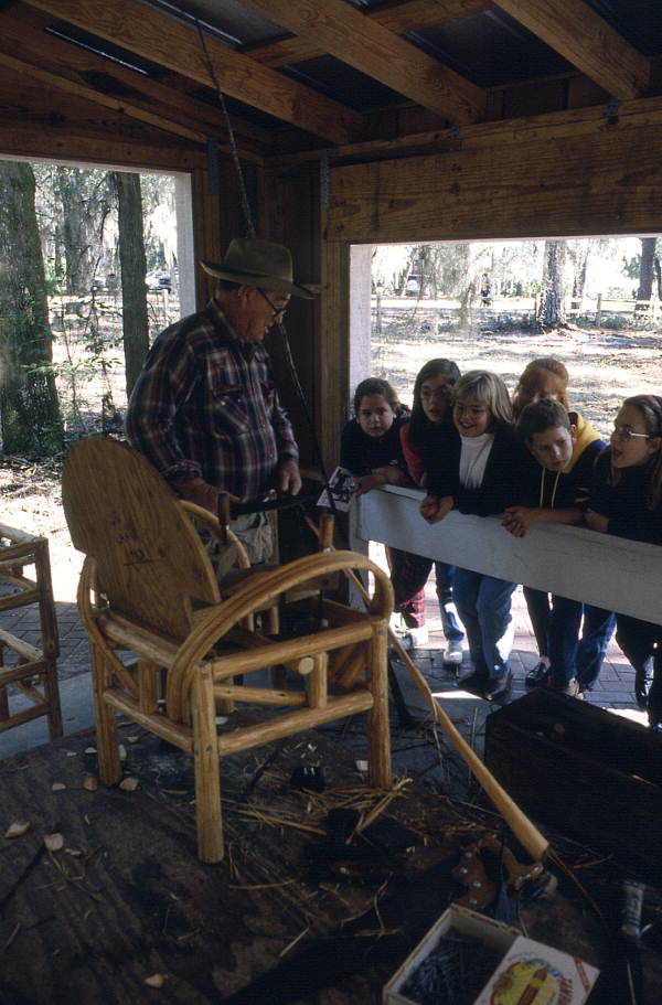 Robert James Rudd giving a cypress furniture making demonstration to school children - White Springs, Florida