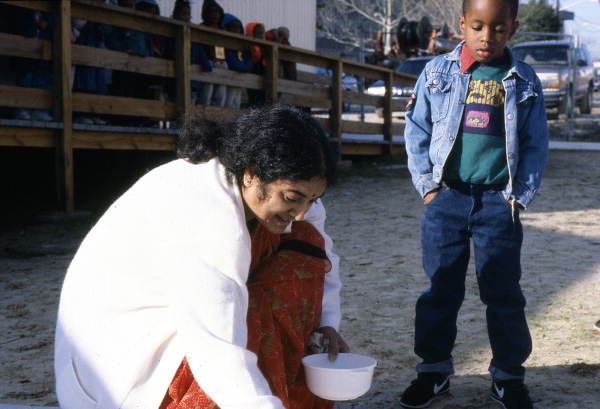 Kindergarten student watching Prema Kumar give a rice flour painting demonstration - Jacksonville, Florida.