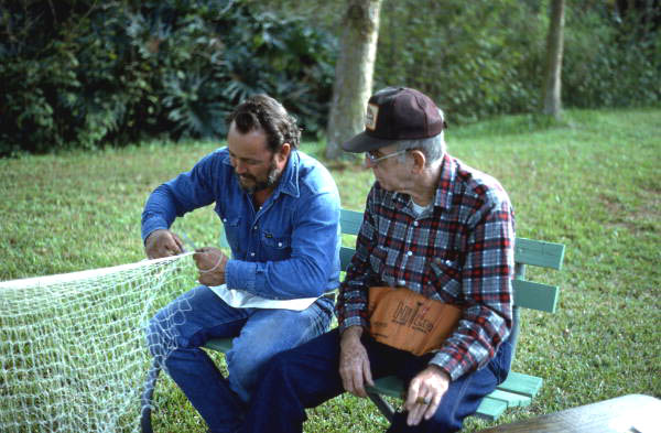Reginald Reis making a cast net while Max Dooley observes - Lakeland, Florida