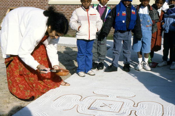 Prema Kumar giving a rice flour painting demonstration to kindergarten students - Jacksonville, Florida.