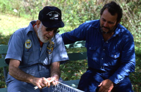 Max Dooley making a cast net while Reginald Reis observes - Lakeland, Florida