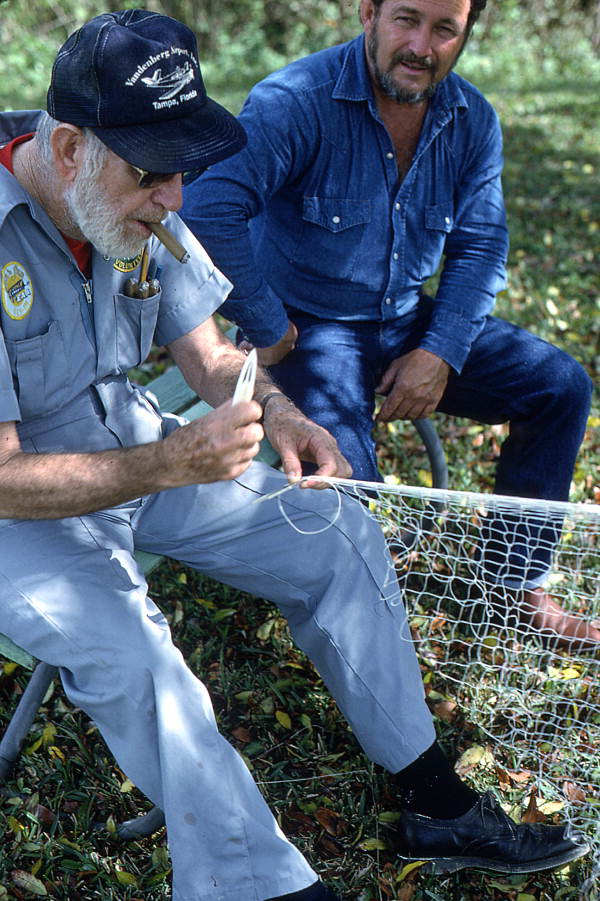 Max Dooley showing apprentice Reginald Reis how to make a cast net - Lakeland, Florida