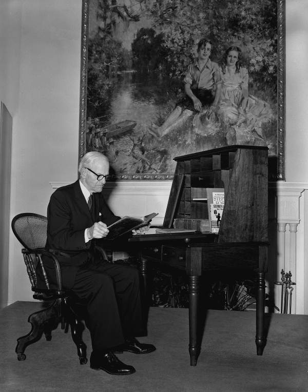Geoffrey O'Hara reading at his desk