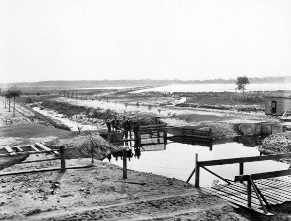Unidentified men by a canal .