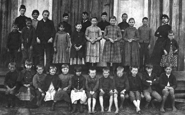 Students posed in front of school building