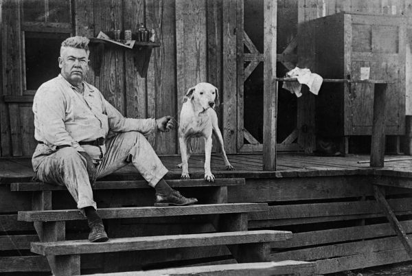 Man on steps of house