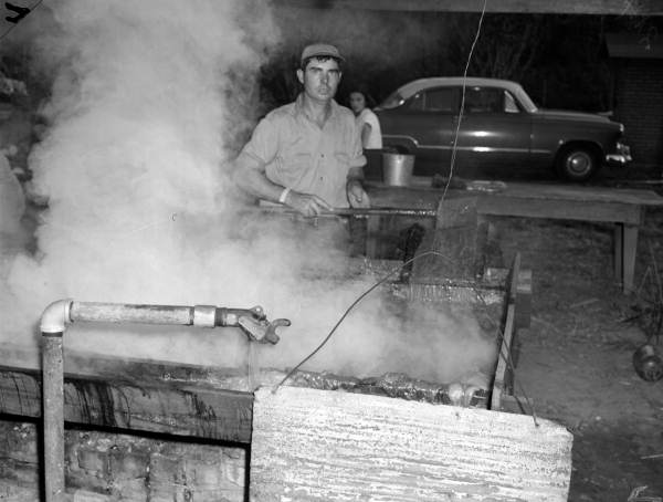 Fresh juice pours into vat as the heavy foam is skimmed - near Tallahassee, Florida