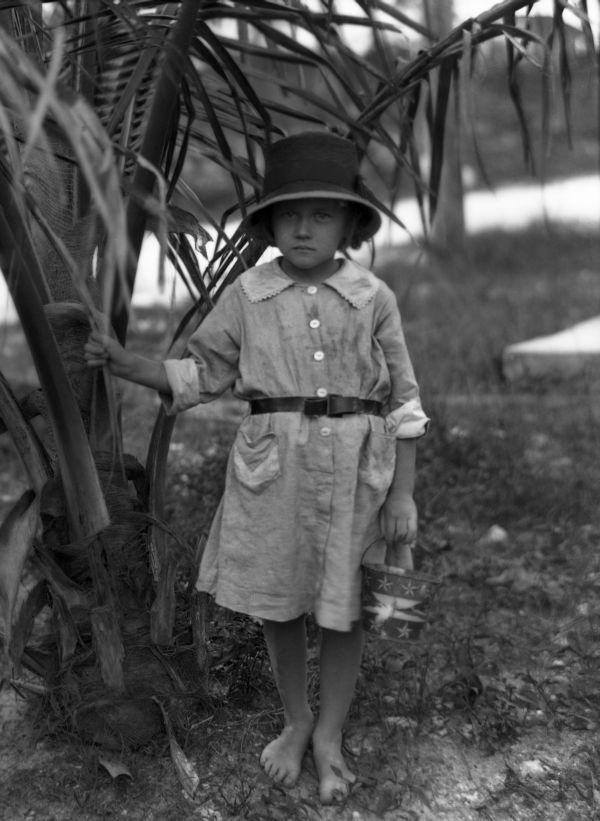 Girl under palm tree