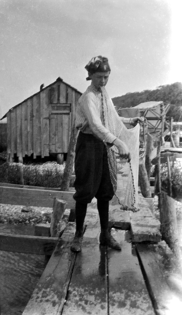 Young man with cast net.