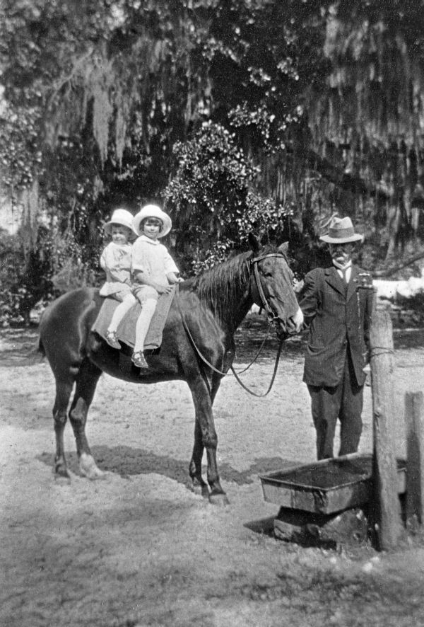 Henry and Margot on horse Daisy held by Frederick A. Fleming.