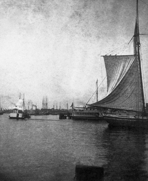 Scene with steam ships and sailing ships.