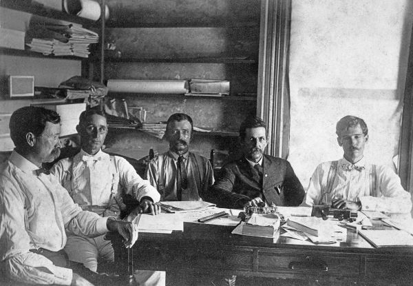 Men seated around desk in office - Jensen Beach, Florida