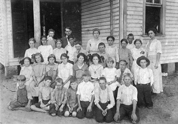 Children shown in front of school