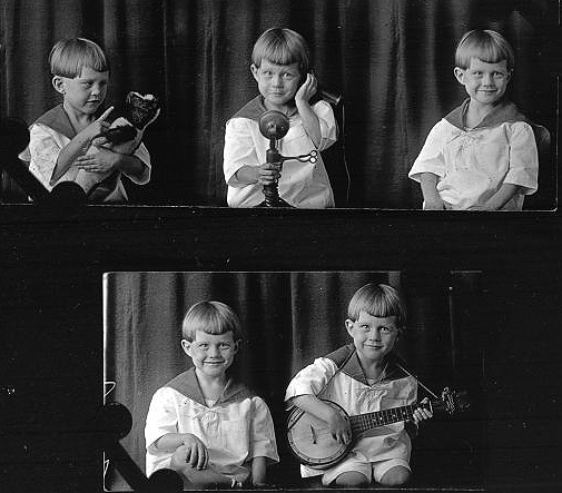 Little boy with bear, telephone and banjo.