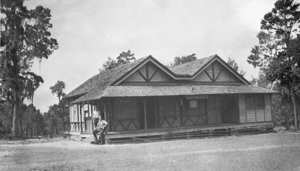 Two men outside the post office and F.W. Mill General Store - Narcoossee, Florida