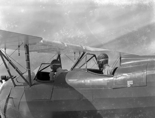 Two trainee pilots from the NYA's Camp Roosevelt in the cockpit of an airplane - Ocala, Florida.