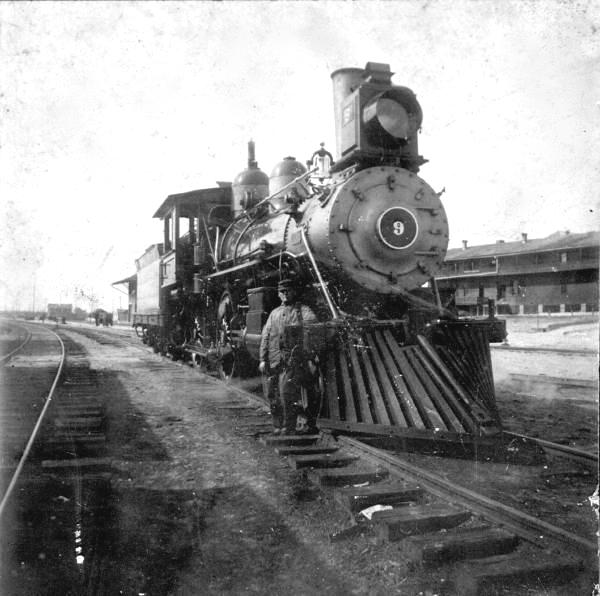 Gus Anderson standing beside engine number 9