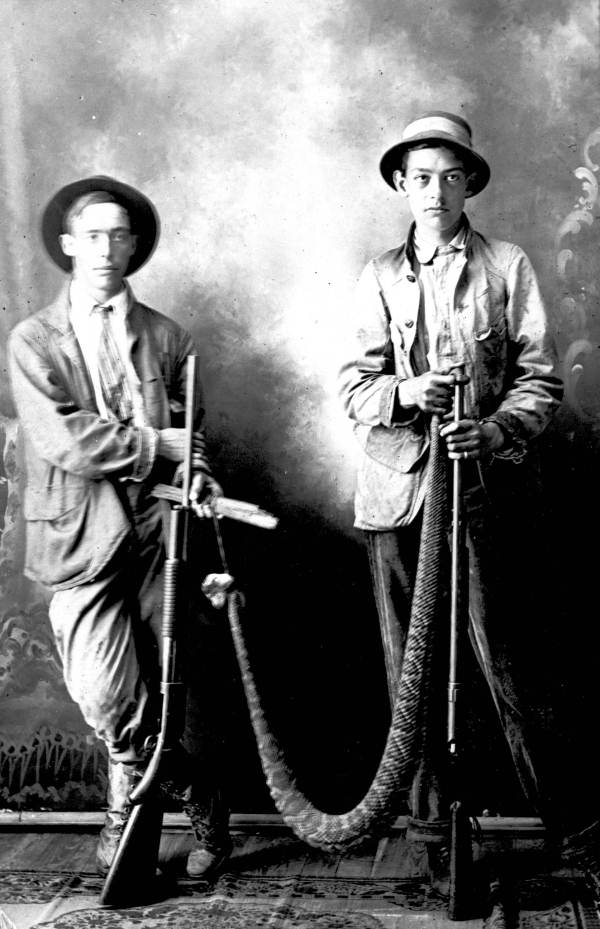 Two hunters with a large rattlesnake