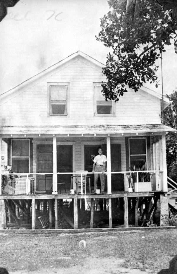 Ridney Albury standing on the porch of his home - Tavernier, Florida.